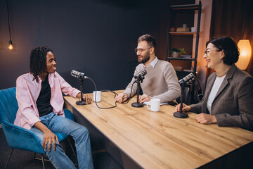 Podcasters talking during a recording session, using professional microphones and audio equipment...