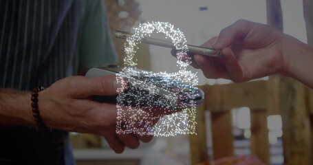 Image of network security padlock over people using payment terminal