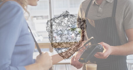 Image of network of connections with security shield over people using payment terminal