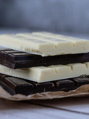 Close-up of stacked white and dark chocolate bars