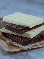 Close-up of stacked white and dark chocolate bars