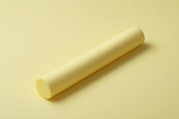 Minimalist Yellow Cylindrical Object on Soft Yellow Background
