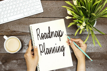 hands holding writing Roadmap Planning Text , desktop