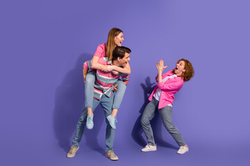 Fototapeta premium Young Friends Enjoy Leisurely Fun on Vibrant Purple Background Highlighting Diversity and Youthful Lifestyle