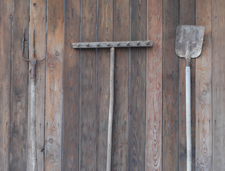 set of rural gardening tools on a wooden wall