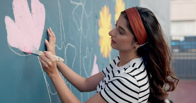 Art, woman and painting mural outdoor for creative design, decoration and volunteer with friends. Artist, girl and painter in city with brush for community wall, floral color and charity project