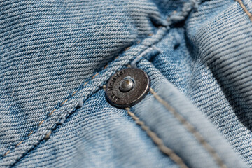 Light blue denim texture jeans with button, background