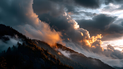 Fototapeta premium Golden clouds drift over mountain tops as dusk sets in.