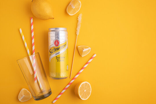 Lviv, Ukraine - April 6, 2025: Iron can of drink Schweppes Indian Tonic with ingredients for cocktail. Top view
