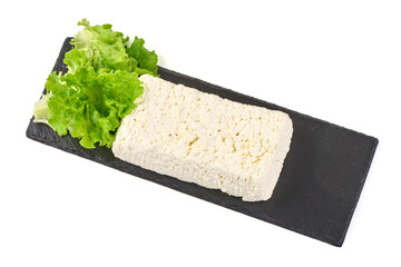 Fresh cottage cheese with lettuce on black slate plate, isolated on white background.