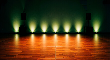 Performance stage with spotlight illumination on wooden floor  
