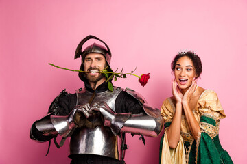 Funny portrayal of a knight and princess in costume with a pink background conveying humor and...