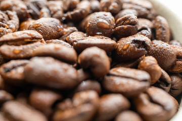 moistened local cultural coffee beans on a rotating background in close-up
