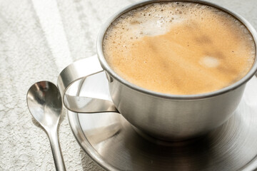 coffee beans, a cup of espresso and ground coffee on wooden background