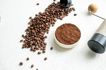 cup of coffee with beans white wooden background
