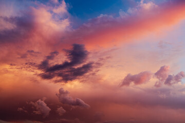 Obraz premium orange and red storm clouds in sky with sunset