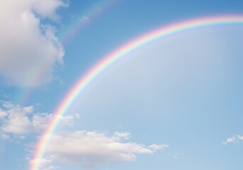 Colorful rainbow over blue sky with clouds and ocean landscape