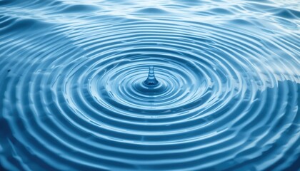 Water drop action creating ripples on a calm surface nature photography serene environment close-up view tranquility concept