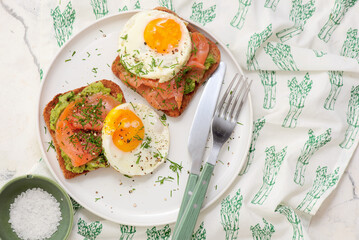 Avocado, Smoked Salmon and Fried Egg Toast for Breakfast for breakfast  .Healthy appetizer.