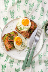 Avocado, Smoked Salmon and Fried Egg Toast for Breakfast for breakfast  .Healthy appetizer.