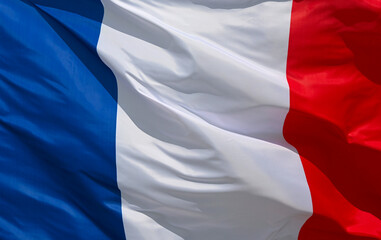 French flag fluttering in the wind, showing the characteristic blue, white and red stripes