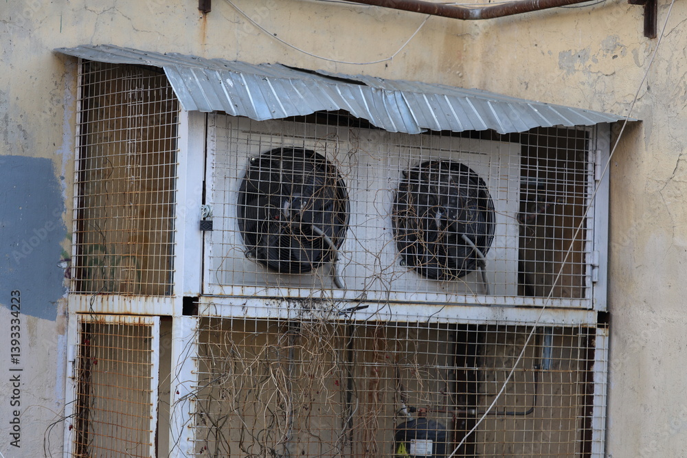 Poster two air conditioning units installed in a window.