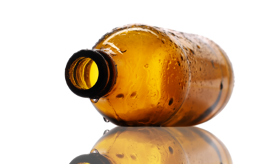 open empty beer bottle with water droplets isolated on white