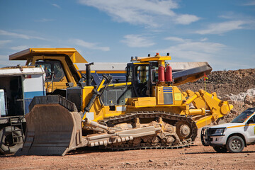 mining truck, bulldozer and a pick-up at a mechanical mobile workshop ready for repairs, at an open...