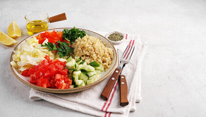 Healthy vegetarian salad with quinoa, tomatoes, green salad and pepper. Close up. copy space