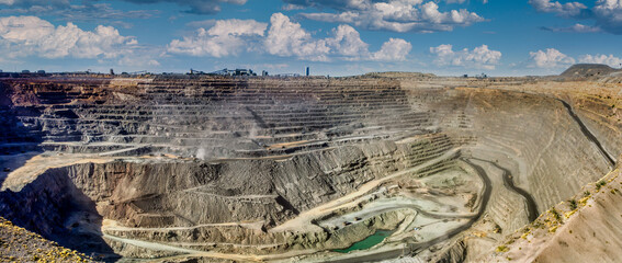 open pit mine, large industrial operation to extract diamonds, several levels deep, processing...