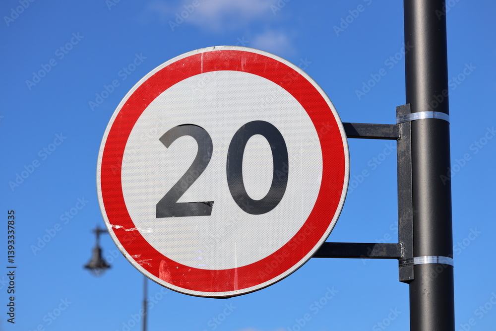 Poster a bright red and white sign with the number 20 prominently displayed.