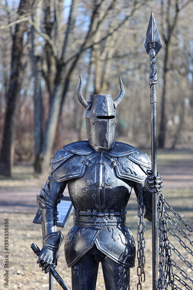 Poster a bronze statue of a knight on top of a chain link fence, ornate details and texture.