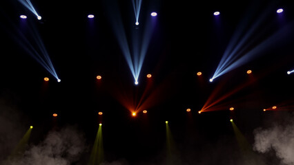 Stage lights background. Light beams and smoke from the stage spotlights on the stage at time of...