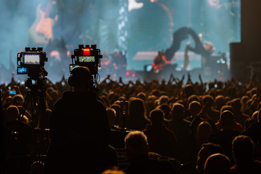 Professional video cameras recording a rock concert
