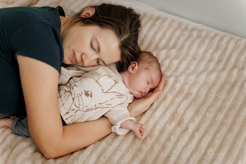 Tender Moment: Mother and Newborn Sleeping Together