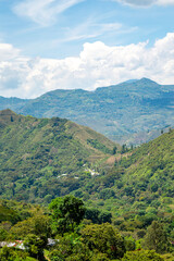 Naklejka premium Breathtaking Mountain Landscape in Cauca, Colombia Surrounded by Lush Greenery and Clear Blue Skies