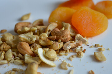 healthy mix of dried apricots and scattered cashew nuts on a clean white background natural textures colors nutritious food choices snacks diet plans wellness clean eating plant-based lifestyle 