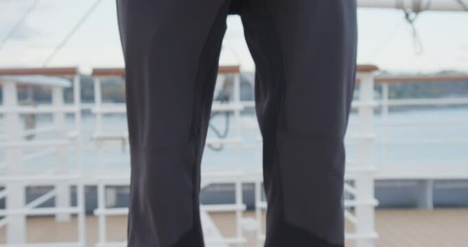 Quick shot of man landing and removing carabiner from his harness and running off, closeup