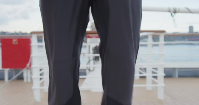 Man landing then removing carabiner from his harness - closeup