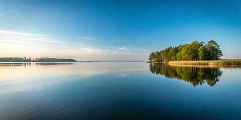 Obraz premium Serene Lakeside Scene in Burtnieks Latvia Calm Waters Reflecting a Minimalist Landscape