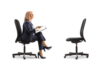 Professional woman sitting opposite an empty office chair