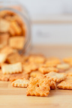 Homemade Cheese Crackers Close-up on Butcher Block Countertop with Jar in Background