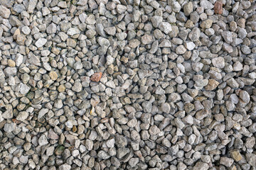 Obraz premium High-resolution close-up of small natural gravel stones. Ideal for backgrounds, construction themes, or nature textures.