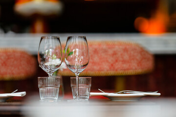 elegant wine glasses on a restaurant table with blurred background.