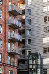 Naklejka premium contrast between brick and metal residential buildings.