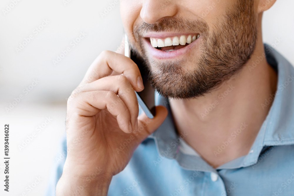 Aufkleber mobile call. handsome millennial man talking on cellphone indoors, smiling guy with stubble enjoying