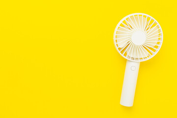 Mini electric fan on color background, top view