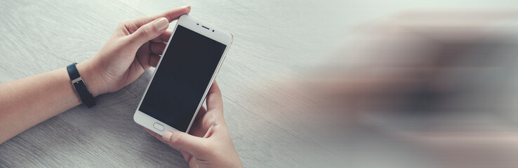 woman hand smart phone on table