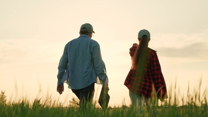 two farmers walk field wheat discussing harvest, teamwork, conversation two agricultural workers,...