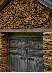 Naklejka premium wooden house with firewood close up